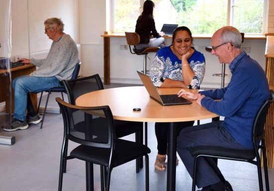 People using laptops and computers at Get Online drop-in