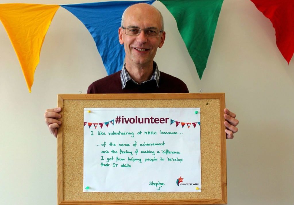 Volunteer Stephen holding sign